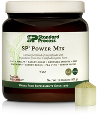 Tub of SP Power Mix next to a scoop of the green powder.